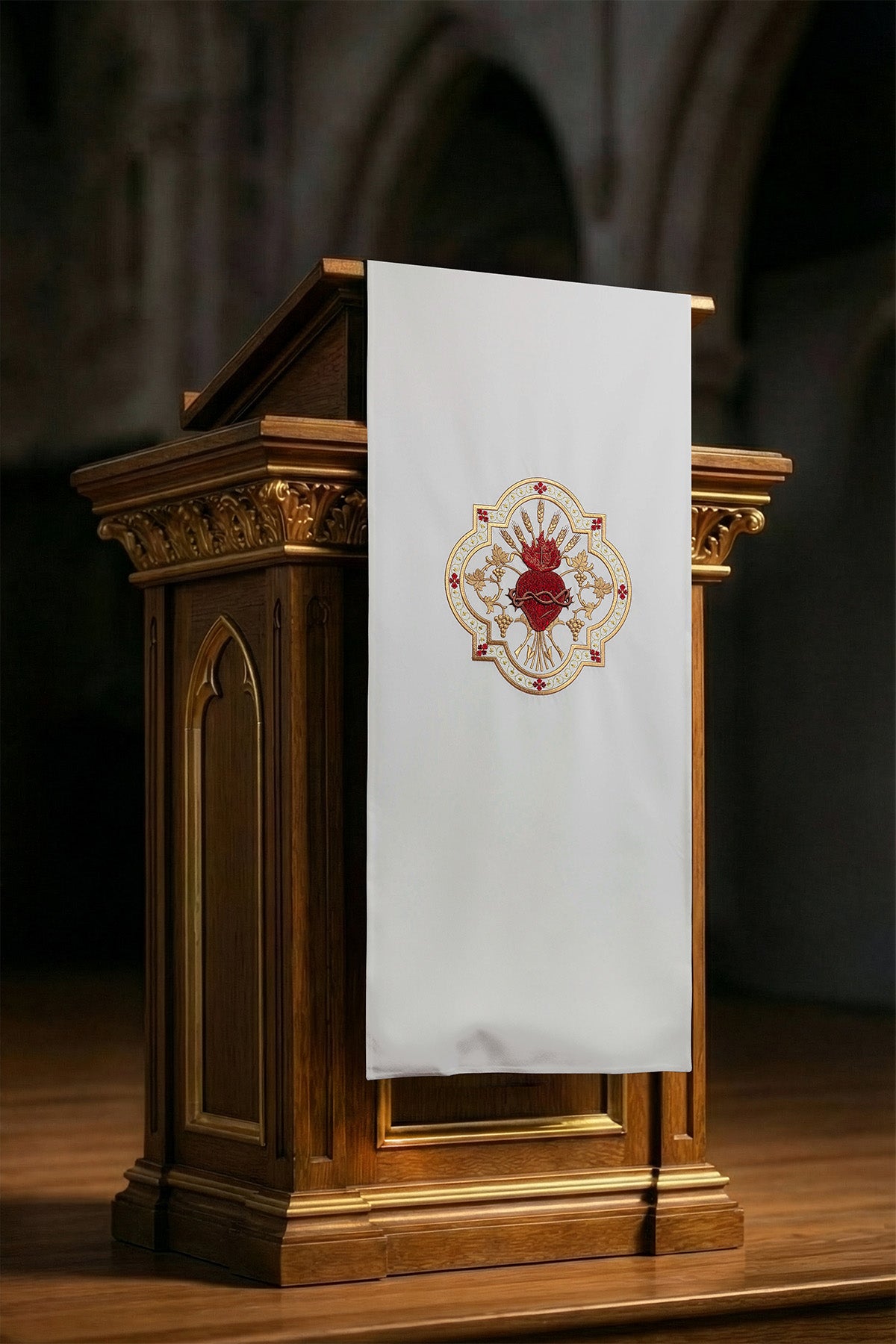 White lectern cover embroidered with a white Sacred Heart motif