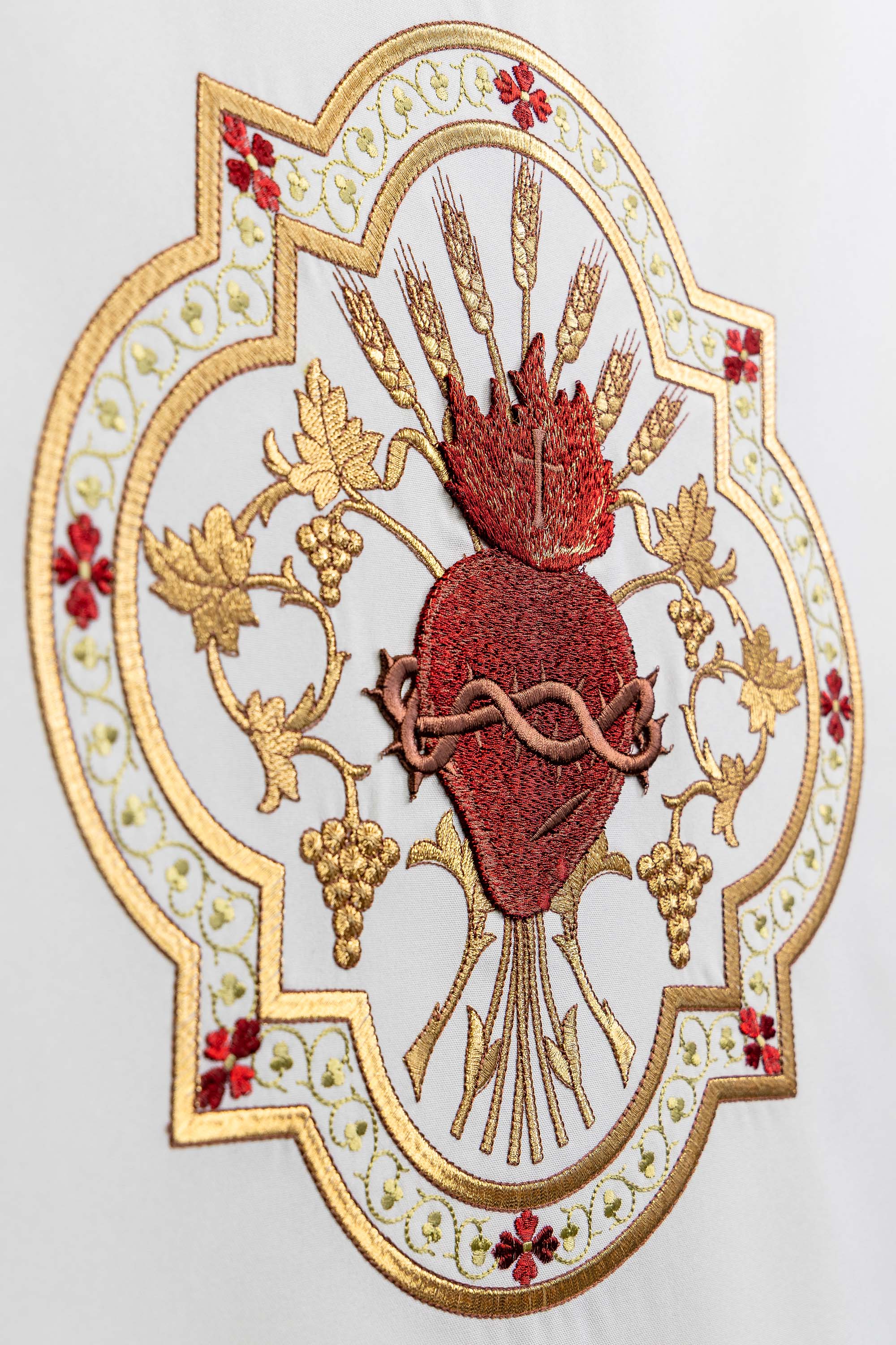 White lectern cover embroidered with a white Sacred Heart motif
