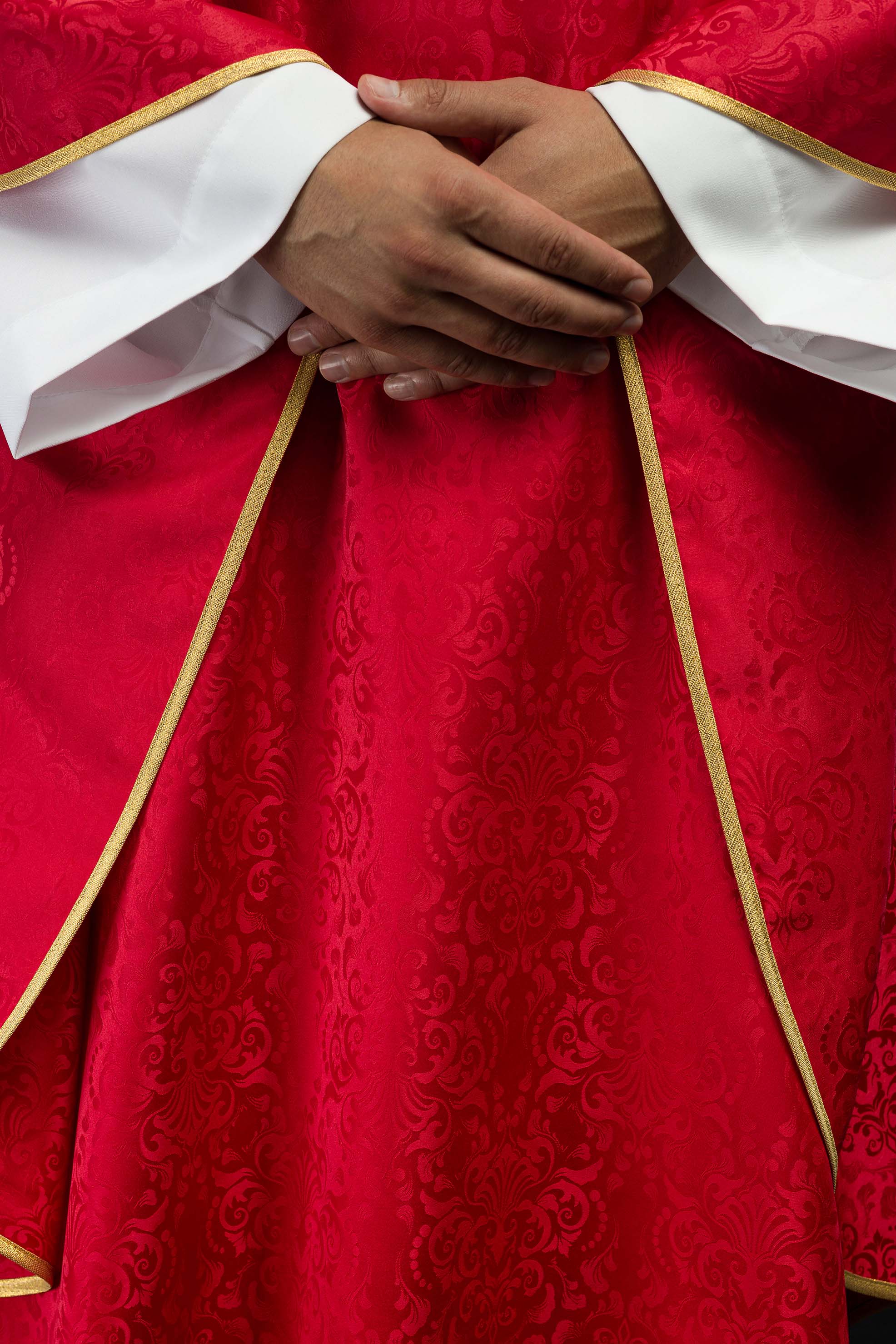 Red liturgical chasuble with embroidered chalice and host on jacquard fabric