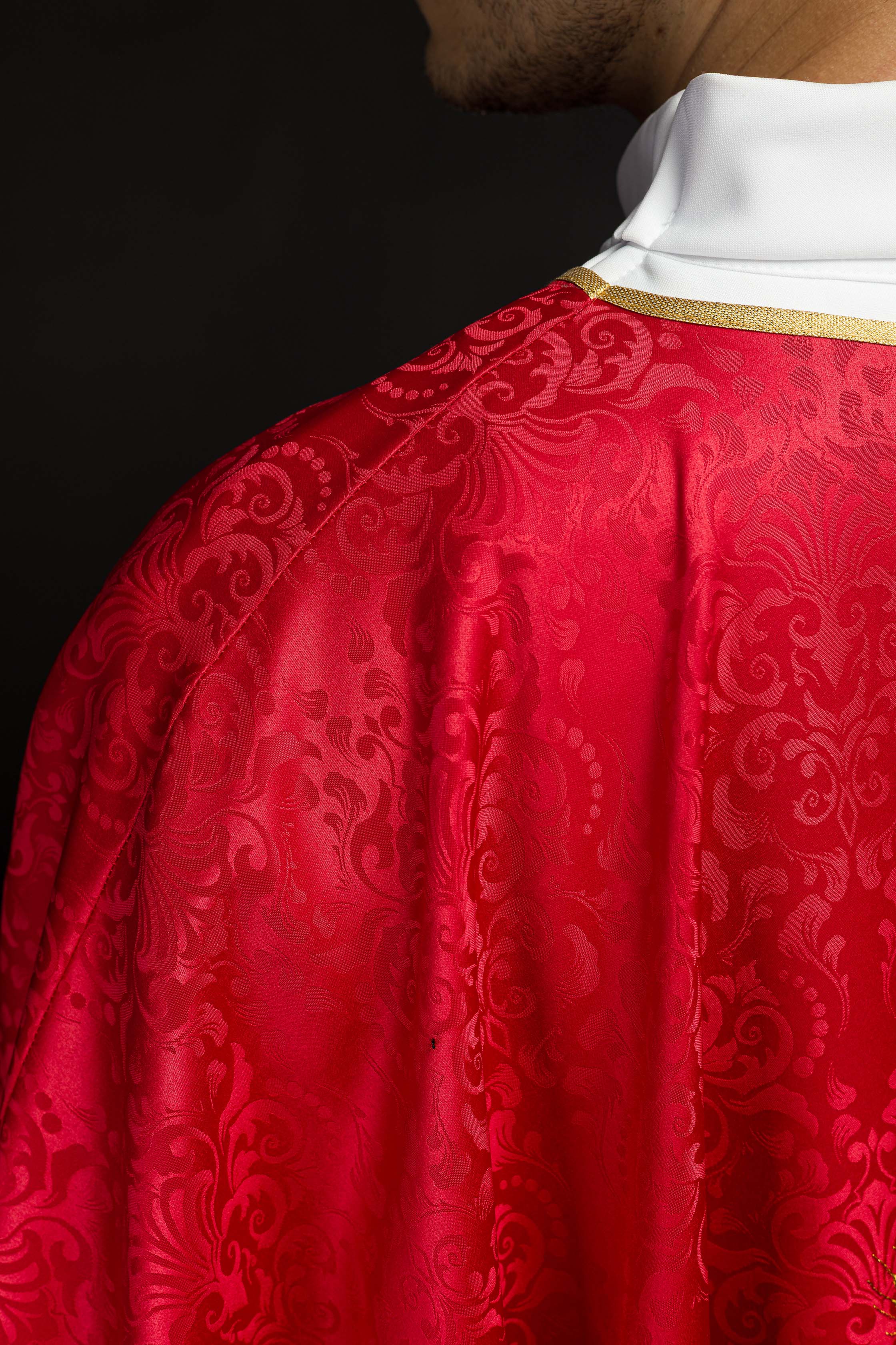 Red liturgical chasuble with embroidered chalice and host on jacquard fabric