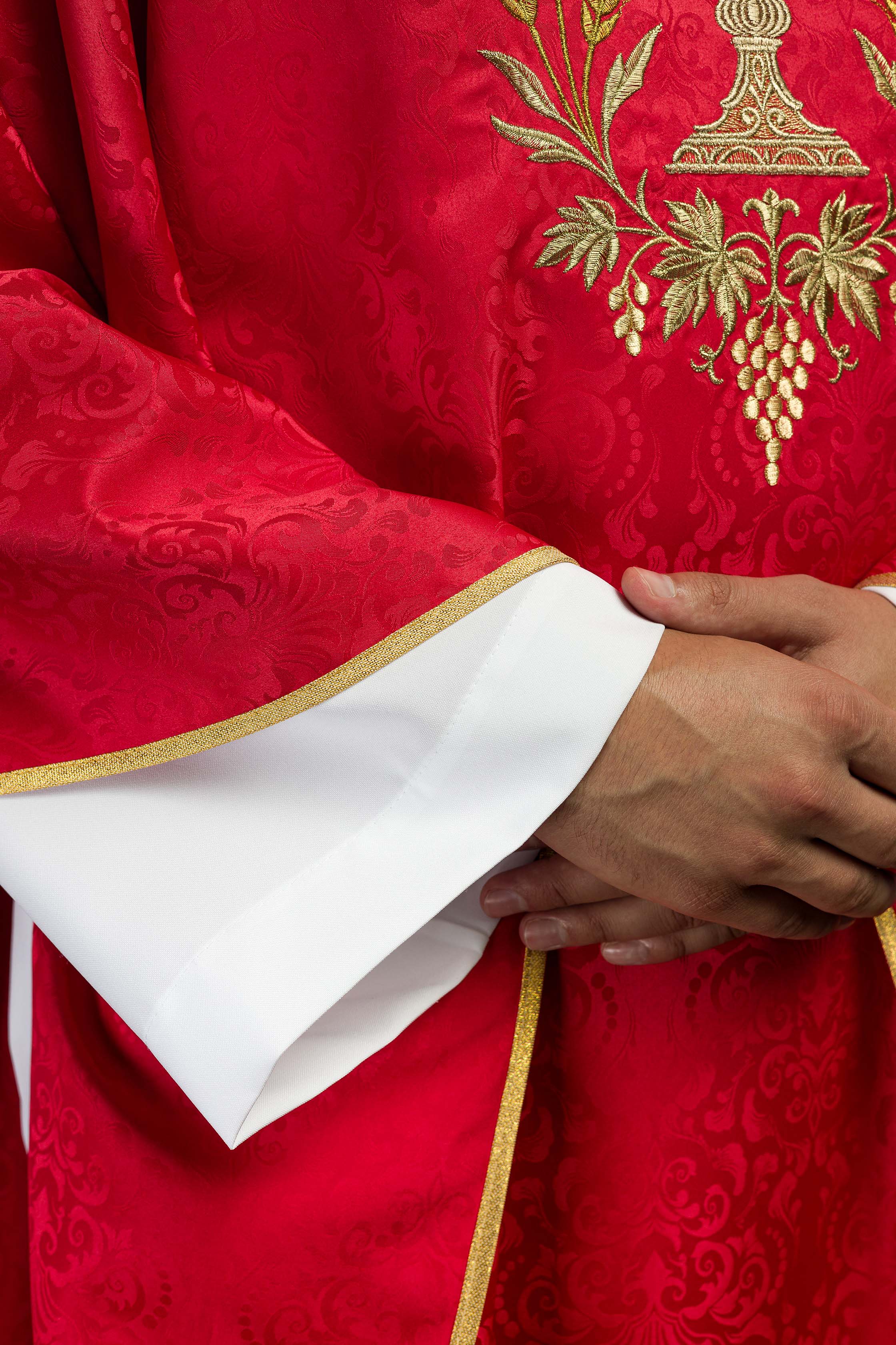 Red liturgical chasuble with embroidered chalice and host on jacquard fabric