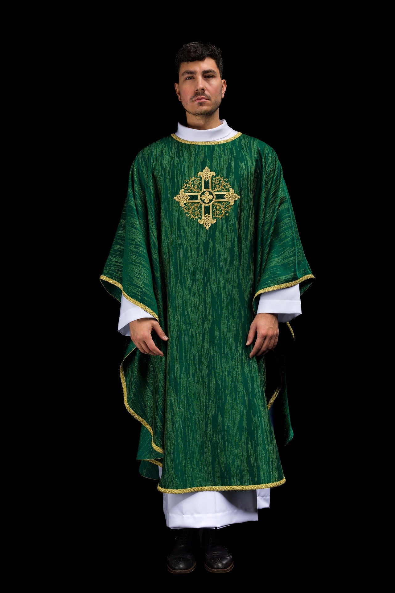 Green chasuble with embroidered cross motif on decorative fabric