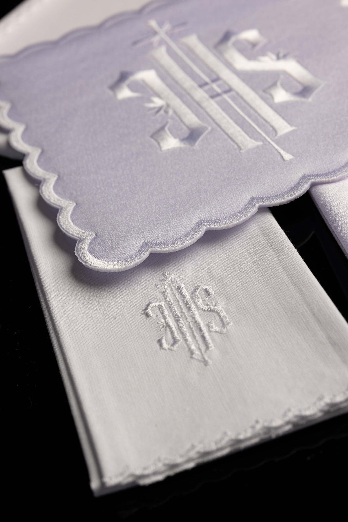 Detail view of the chalice linen set showing IHS embroidery and white stitched edging
