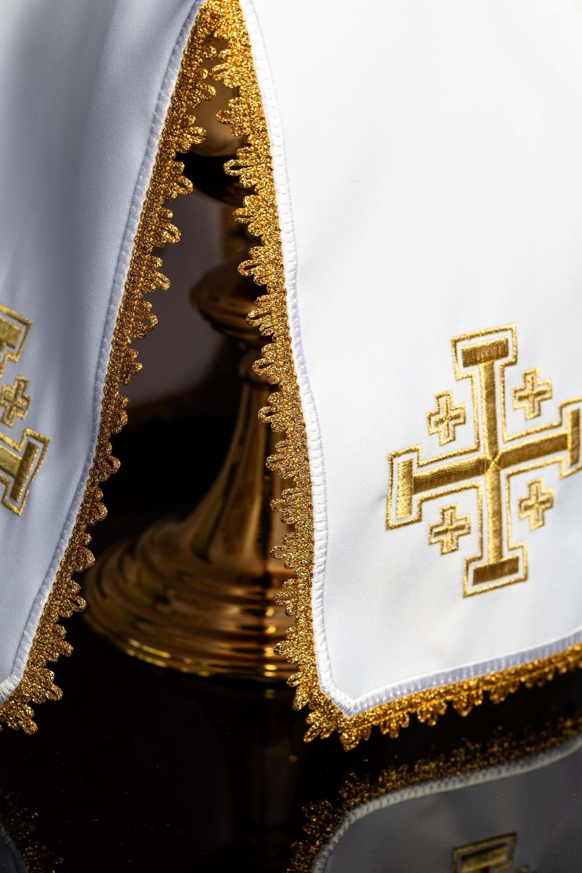 Detail view of the white ciborium veil showing gold lace trim and Jerusalem Cross embroidery