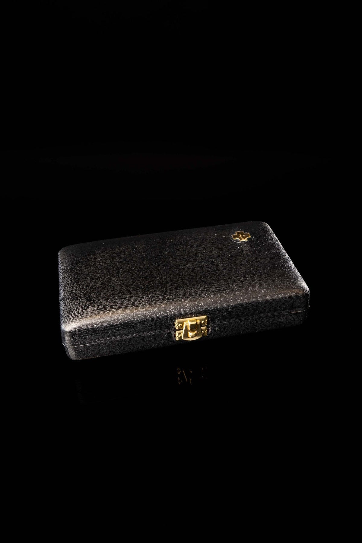 Closed view of the black hard case for the liturgical burse set with gold clasp