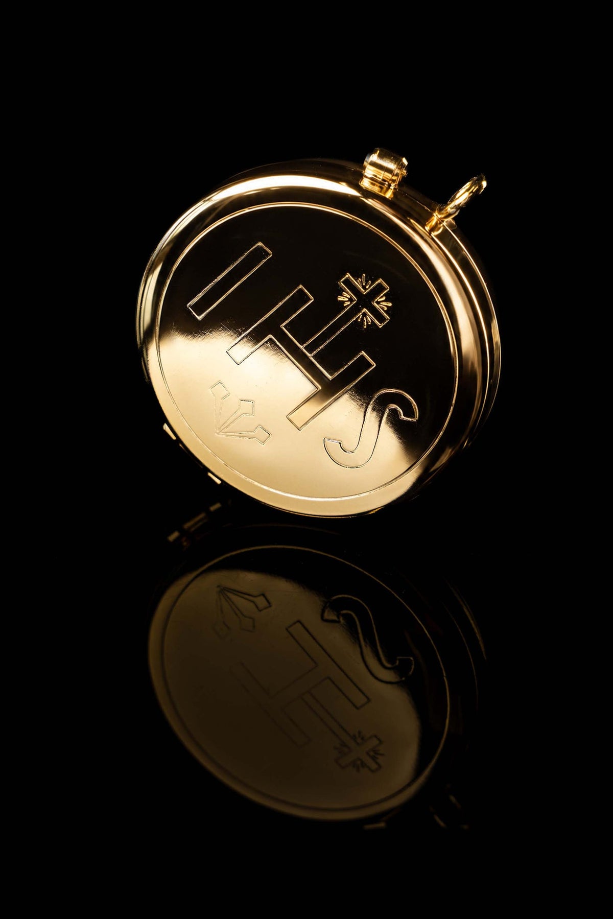 Angled view of the Gold-Plated Ciborium Engraved with IHS, showing the closed lid and cross design