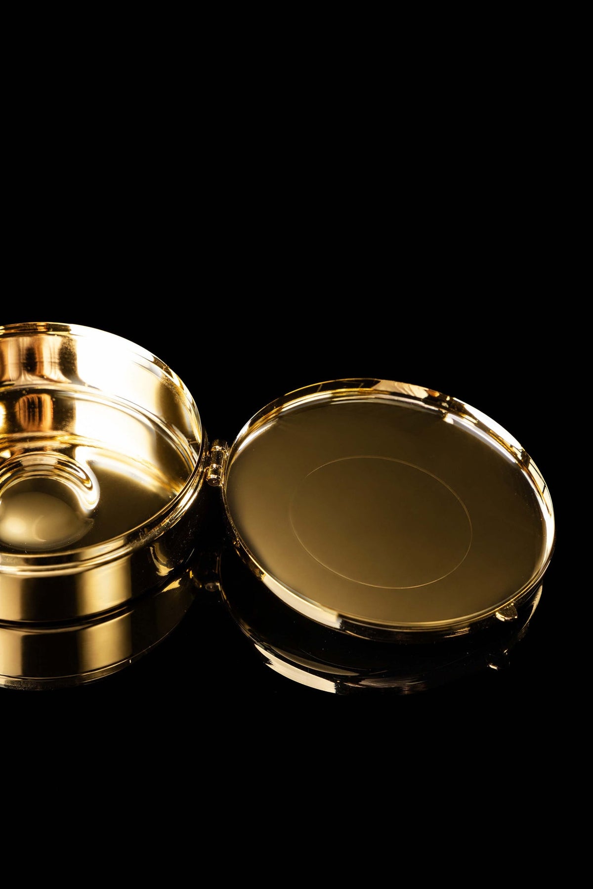 Open view of the gold-plated ciborium showing the hinged lid and polished interior