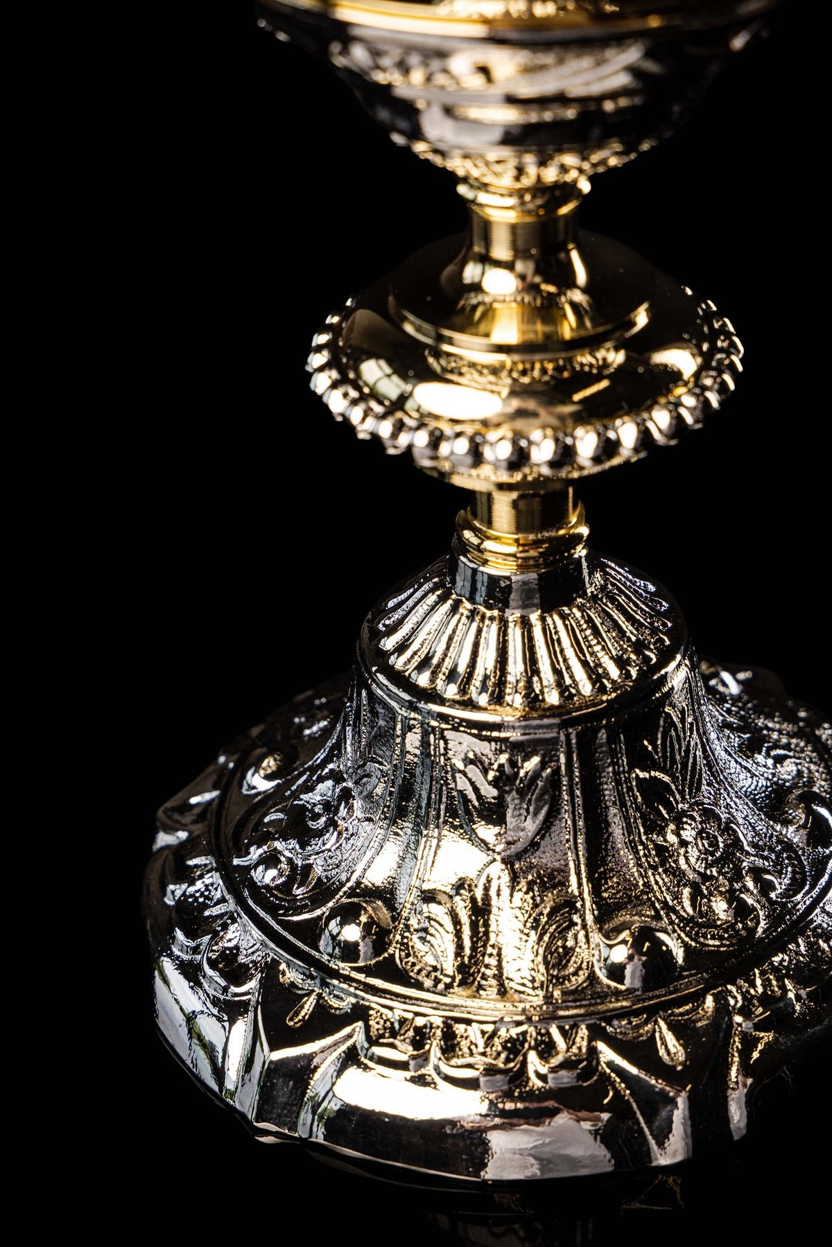 Close-up of the chalice base with floral and scrollwork relief