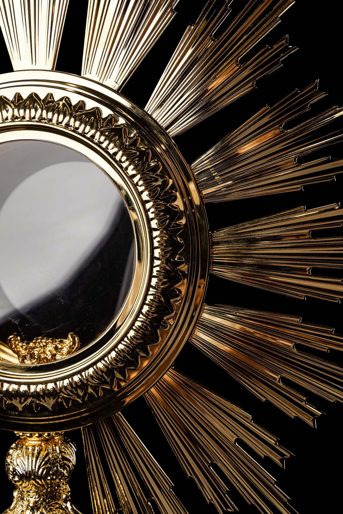 Close-up of the monstrance showing gold-plated rays and ornate central rim