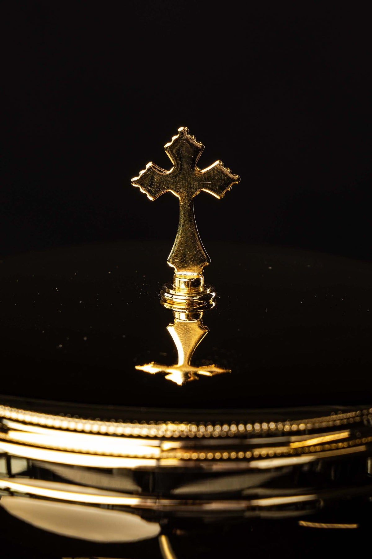 Close-up of the ciborium lid with decorative cross and beaded rim