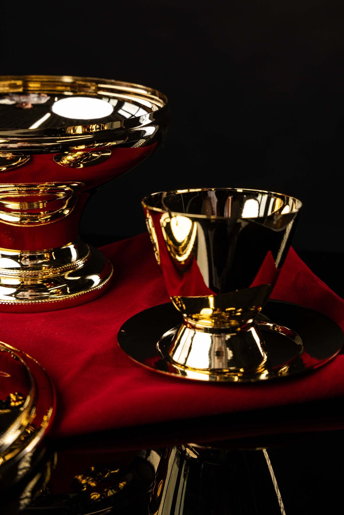 Ciborium with decorative cross shown among matching liturgical vessels