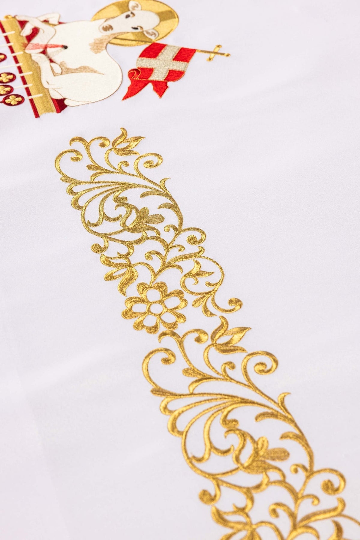 Close-up of the Easter altar cloth showing a gold floral scroll embroidery