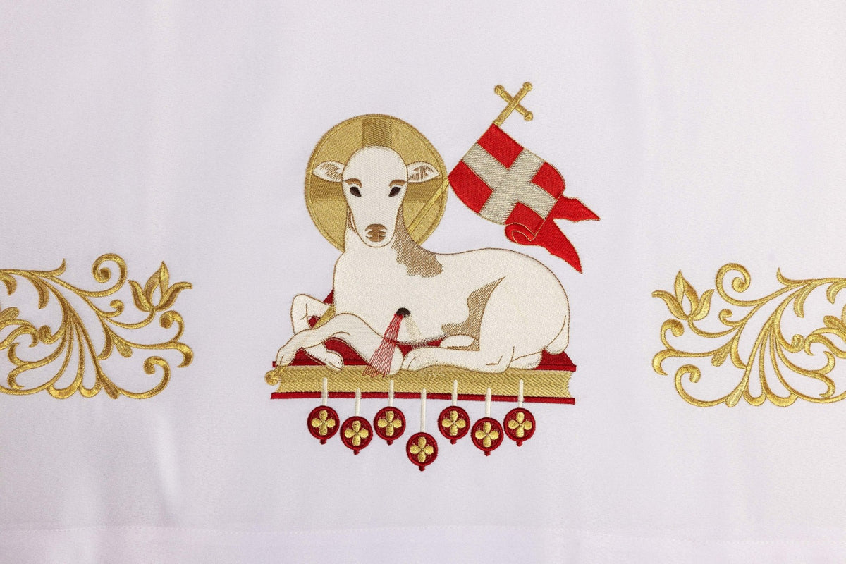 Close-up of the Easter altar cloth showing the embroidered lamb with red banner and gold halo