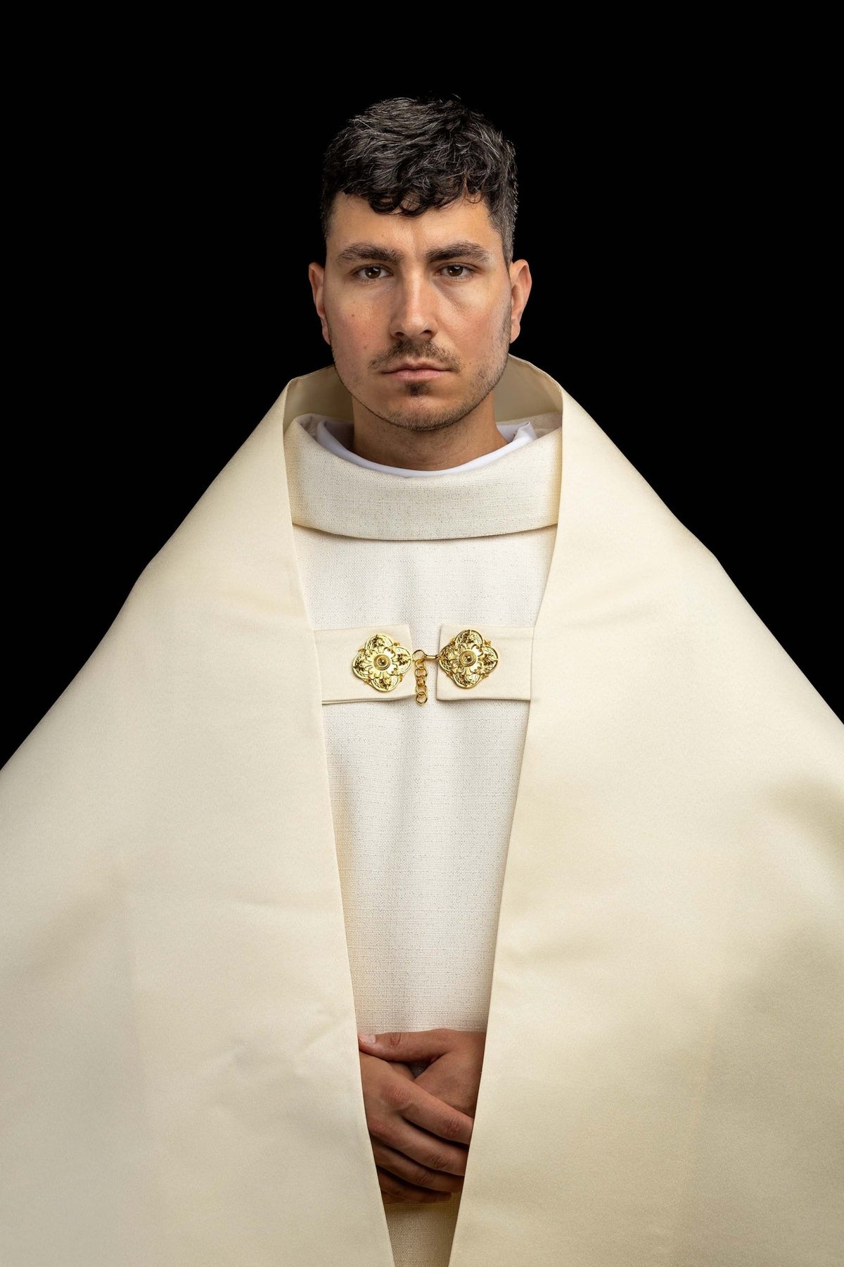 Front worn view of the ecru humeral veil showing gold clasp