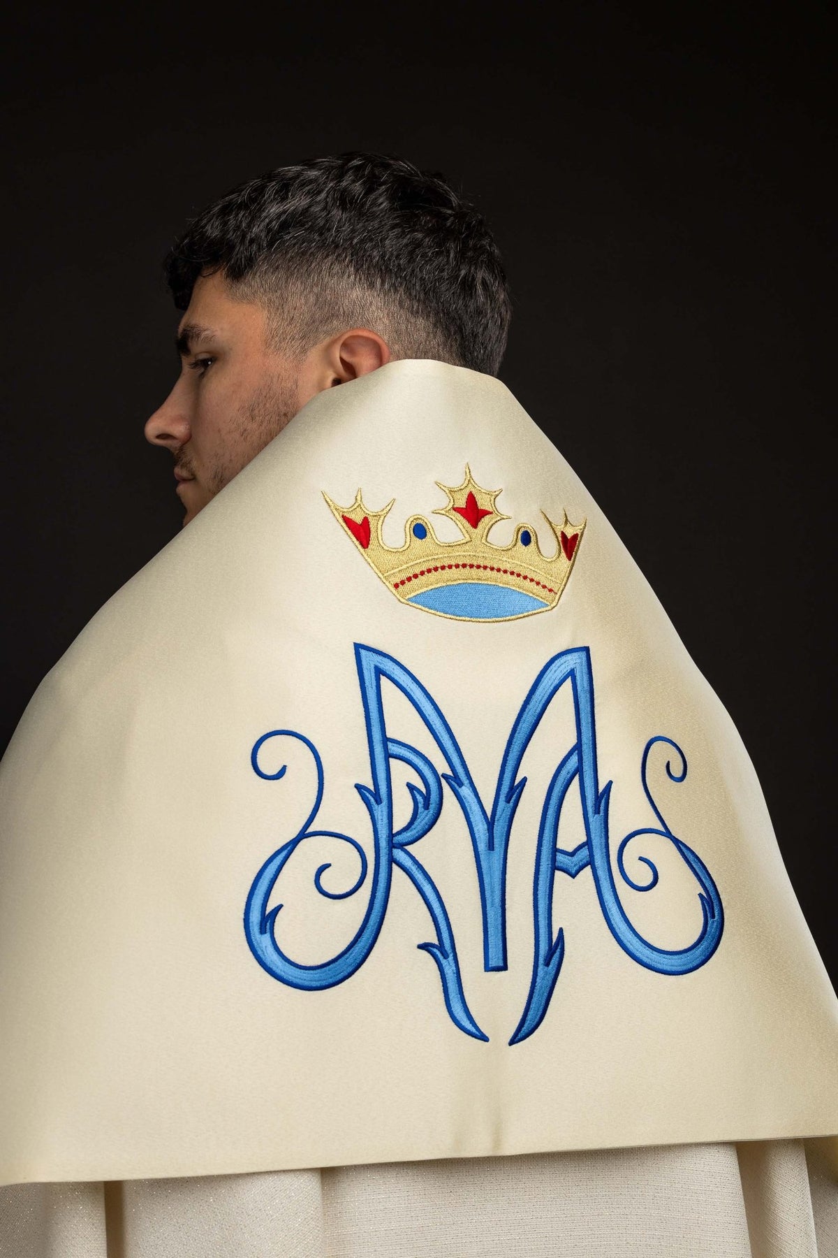 Worn back view of an Ecru Humeral Veil with Embroidered Marian Symbol showing blue Marian monogram and crown