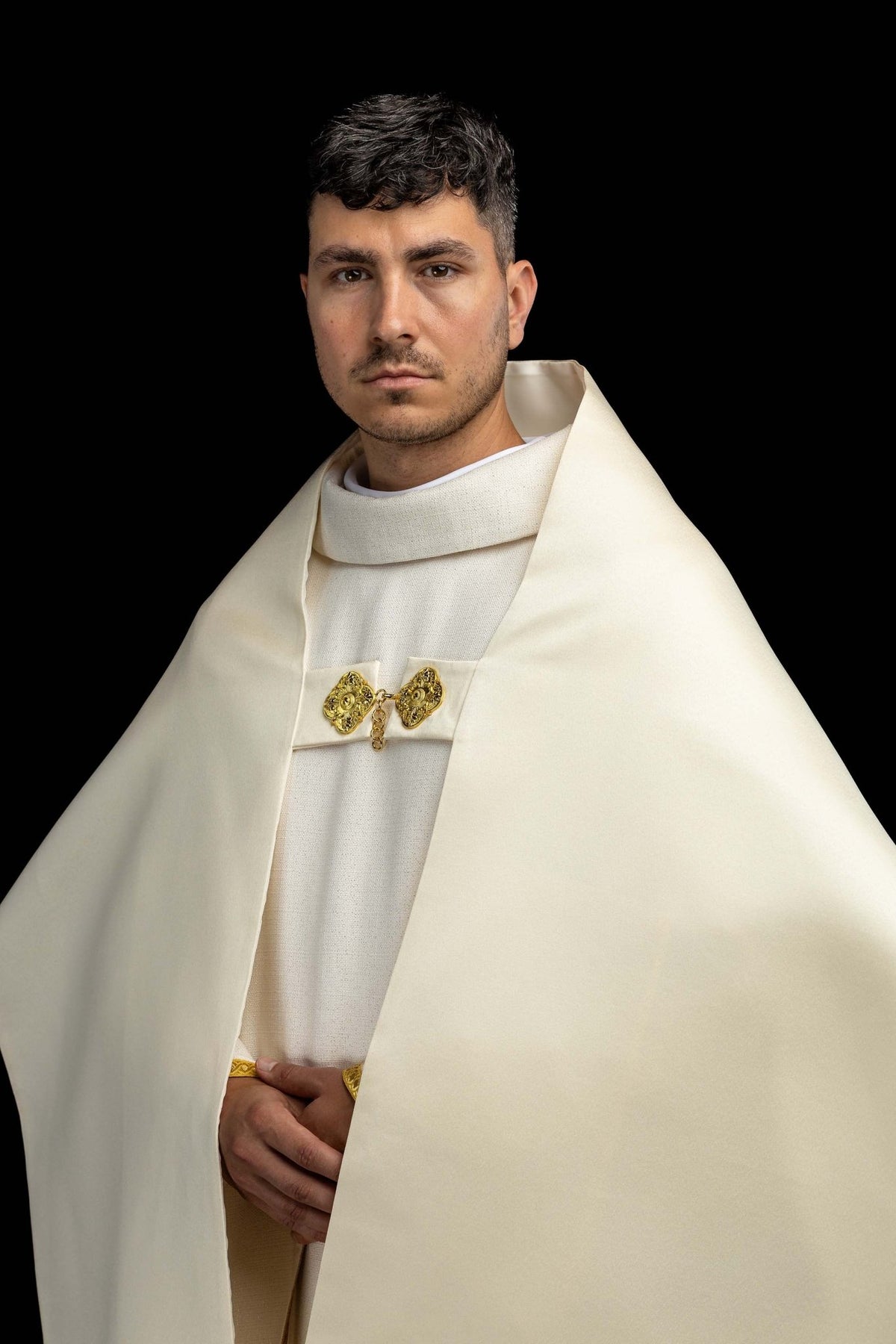 Front view of the humeral veil showing the gold clasp and plain ecru panels