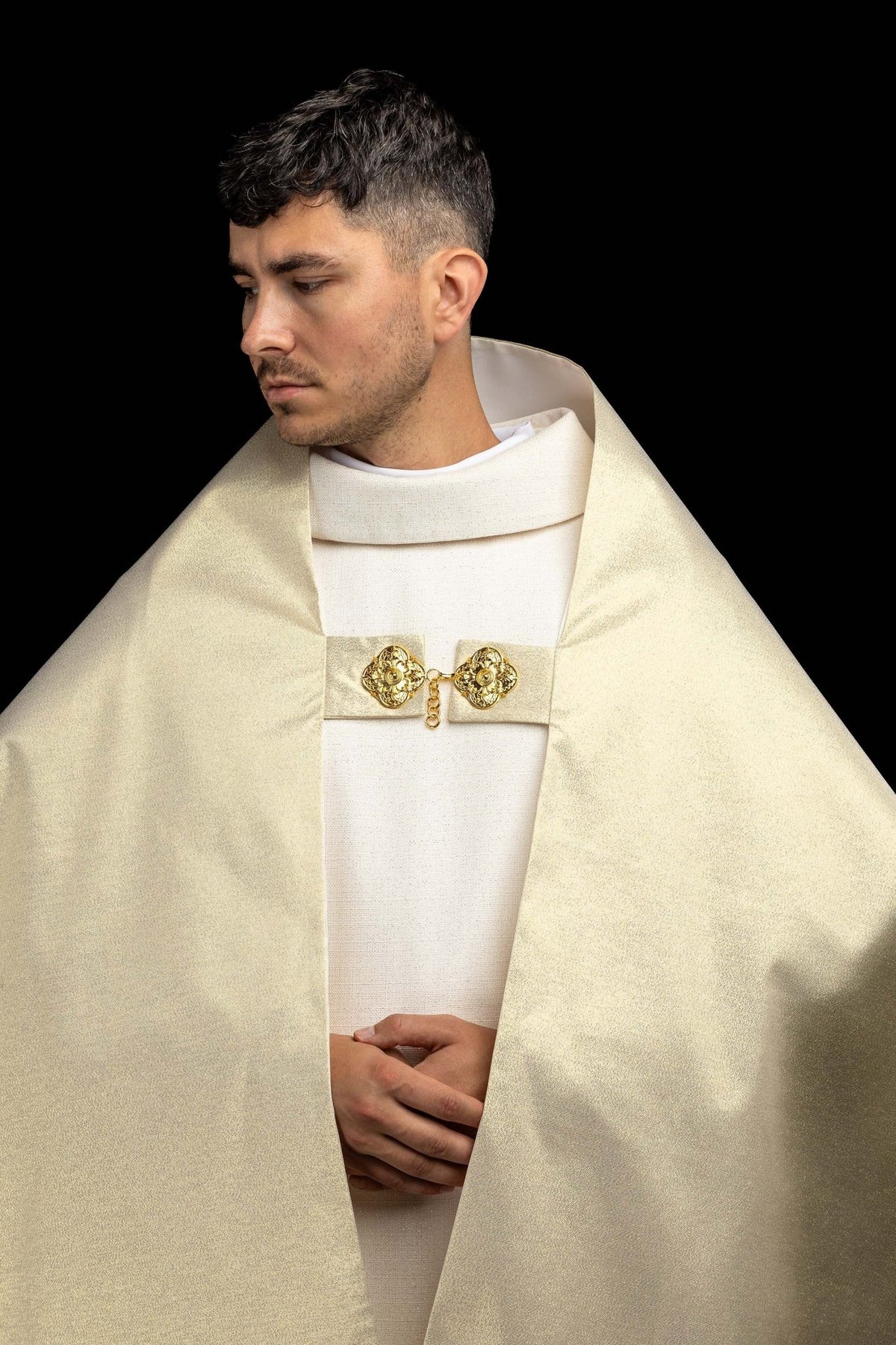 Front view of the humeral veil showing its gold fabric and ornate clasp