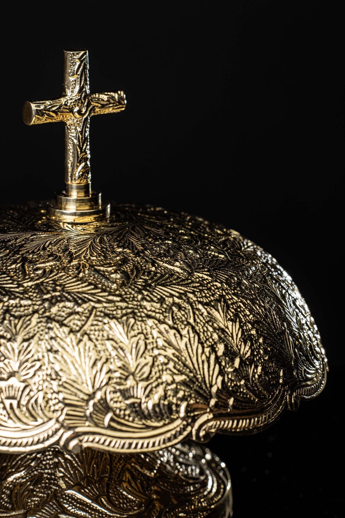 Close-up of the brass gong dome with floral relief and scalloped edge