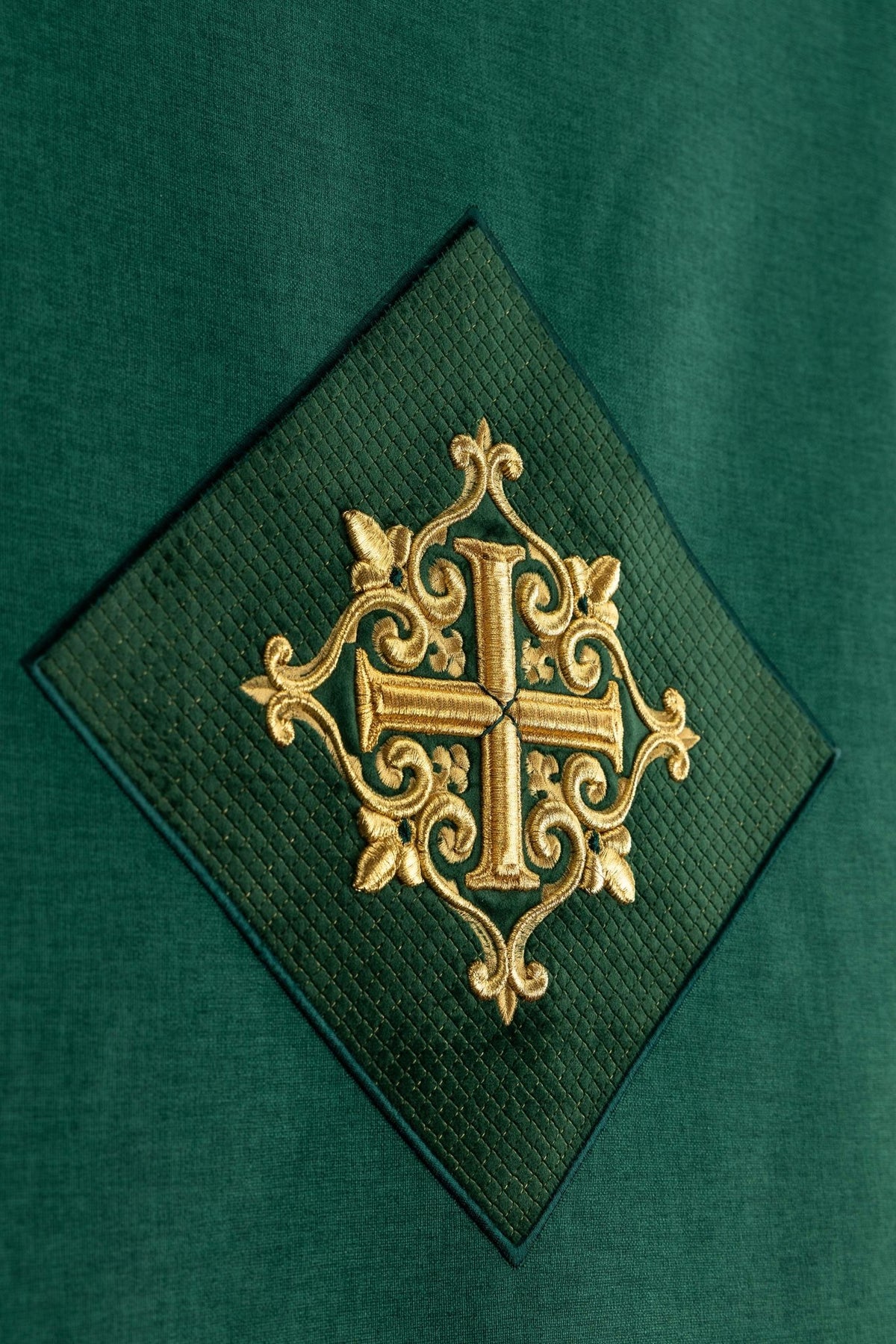 Detail view of the lectern cloth showing the cross applique with diamond-textured stitching