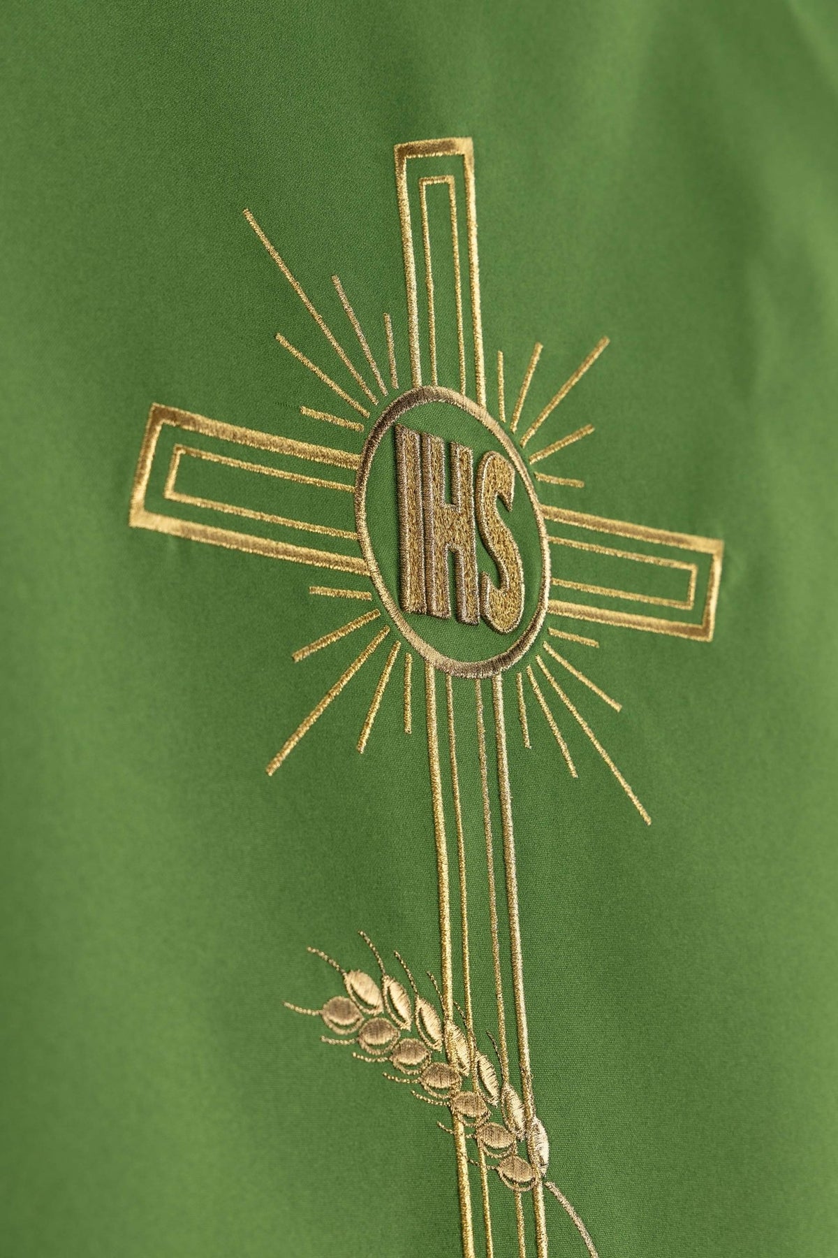 Detailed view of the green lectern cloth showing the IHS cross and wheat embroidery
