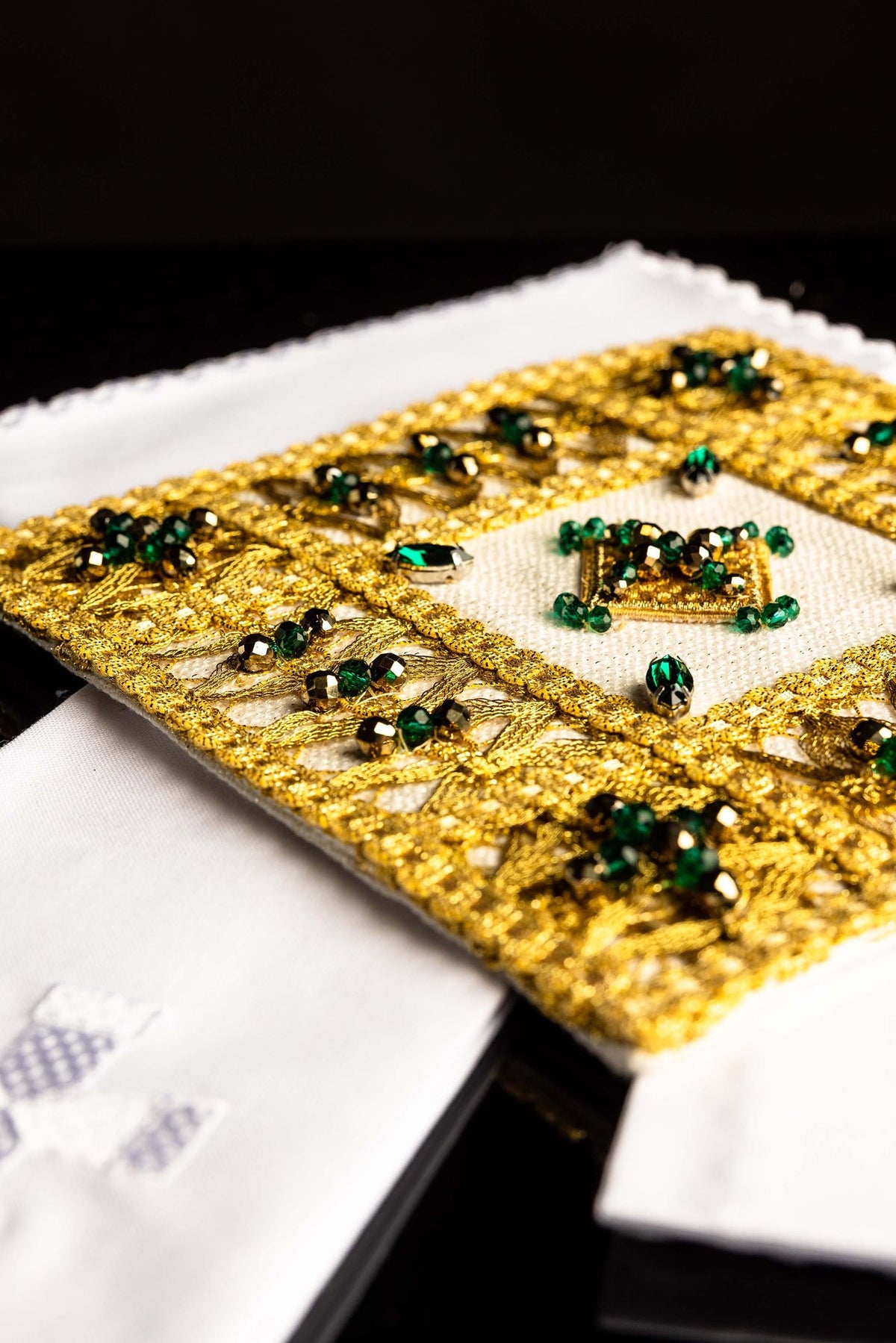 Top detail of the altar linen set's gold pall embroidery and jeweled central motif