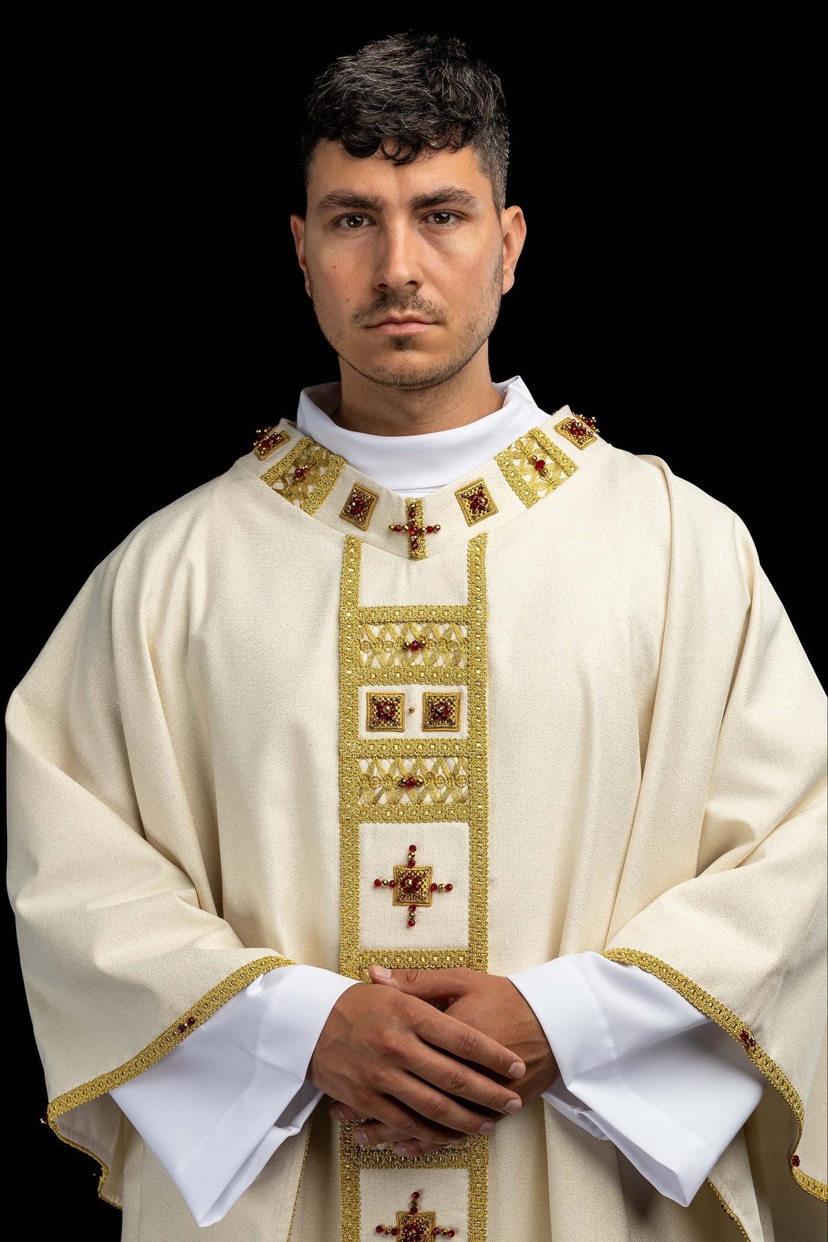 Front view of a Handmade Chasuble Embellished with Natural Stones, 7005 in ivory with gold trim and red stones