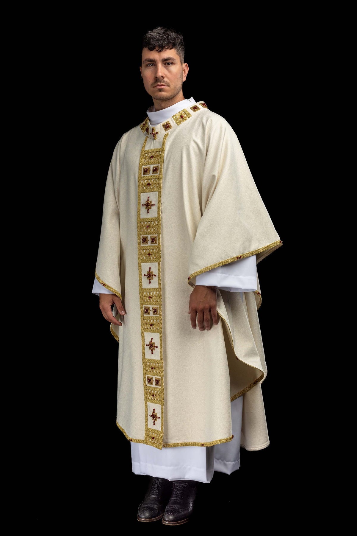 Side view of the ivory handmade chasuble with gold edging and jeweled vertical panel