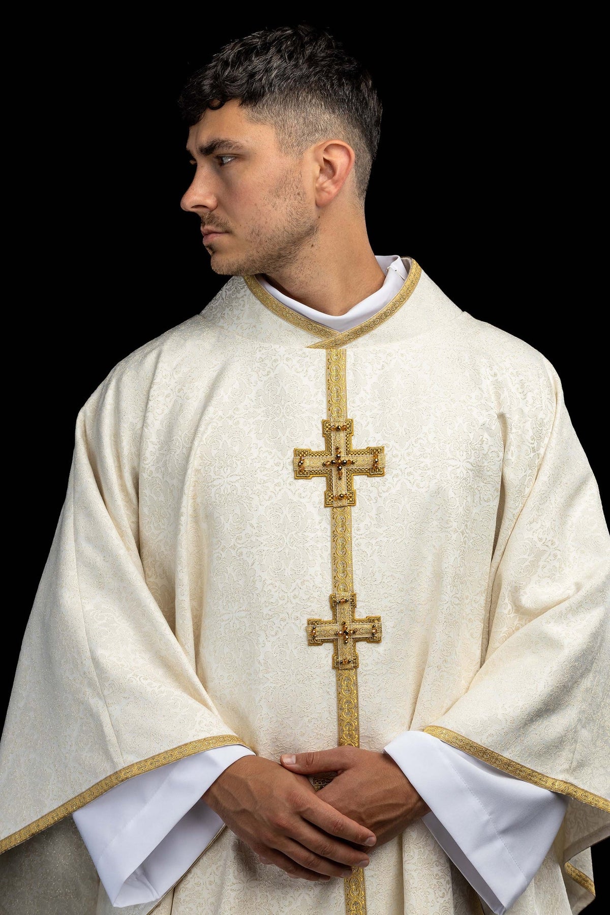 Upper front view of a handmade chasuble with embroidered 3D crosses and natural stones
