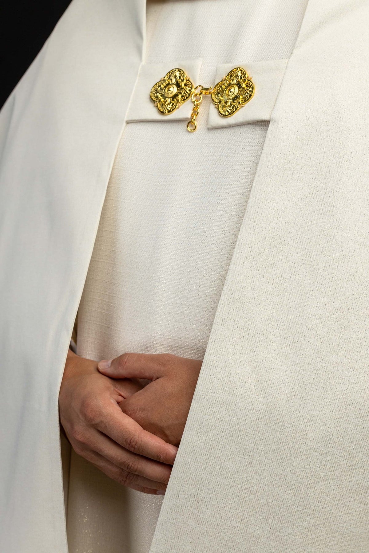 Front detail of the humeral veil with gold clasps and ecru fabric