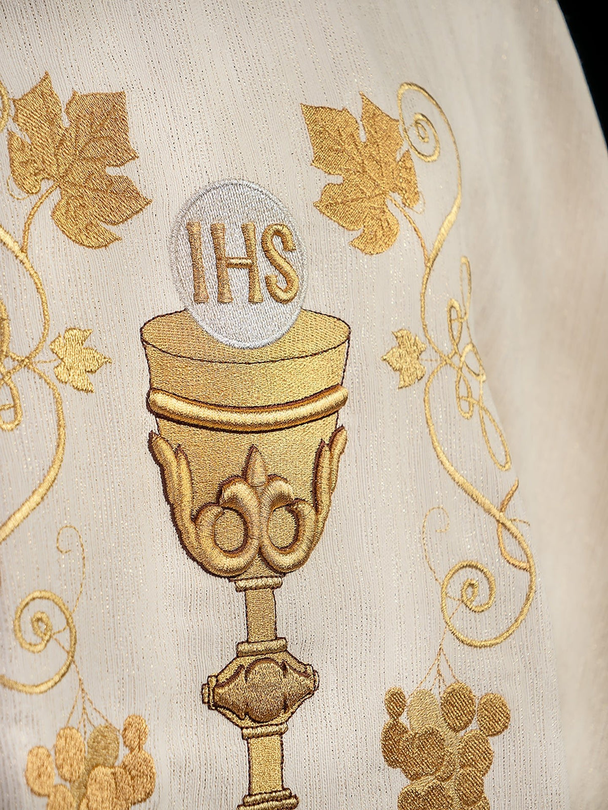 Detail of ecru chasuble showing gold chalice, IHS and vine embroidery
