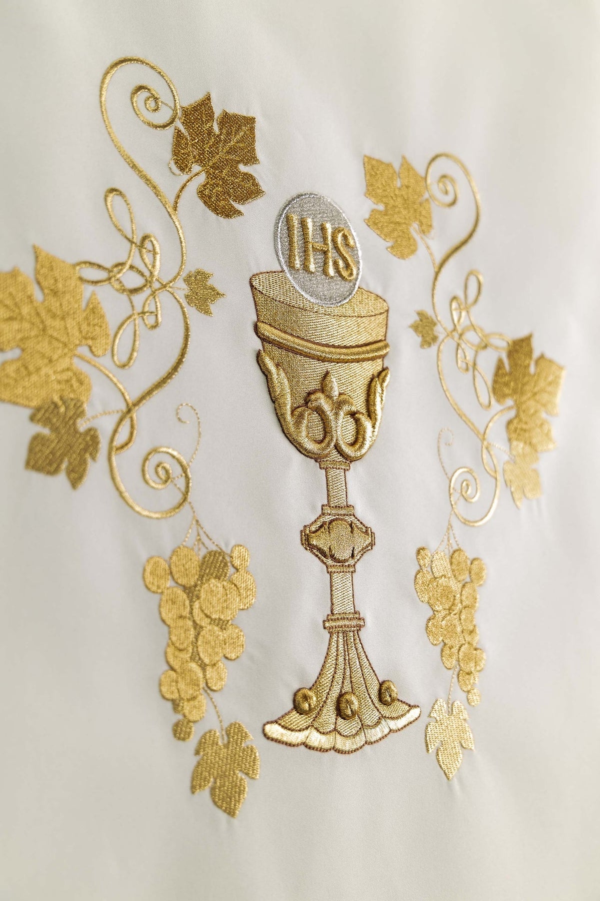 Close-up of the chalice, IHS monogram and grapes on a church lectern cover