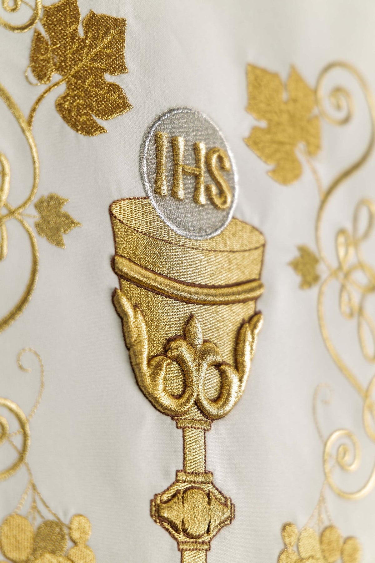 Detailed view of the gold chalice embroidery and IHS monogram on a church lectern cover