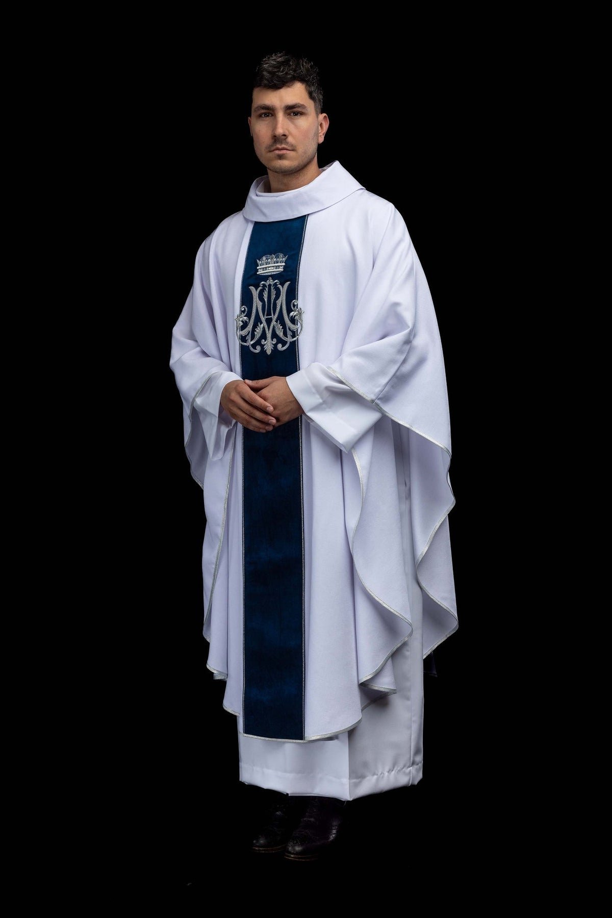 Three-quarter front view of the ecru Marian chasuble with silver embroidered monogram
