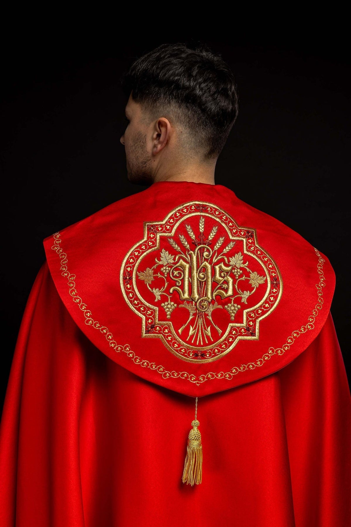 Back view of Red Liturgical Cope Embroidered with IHS and Floral Motifs, with gold IHS embroidery and tassel