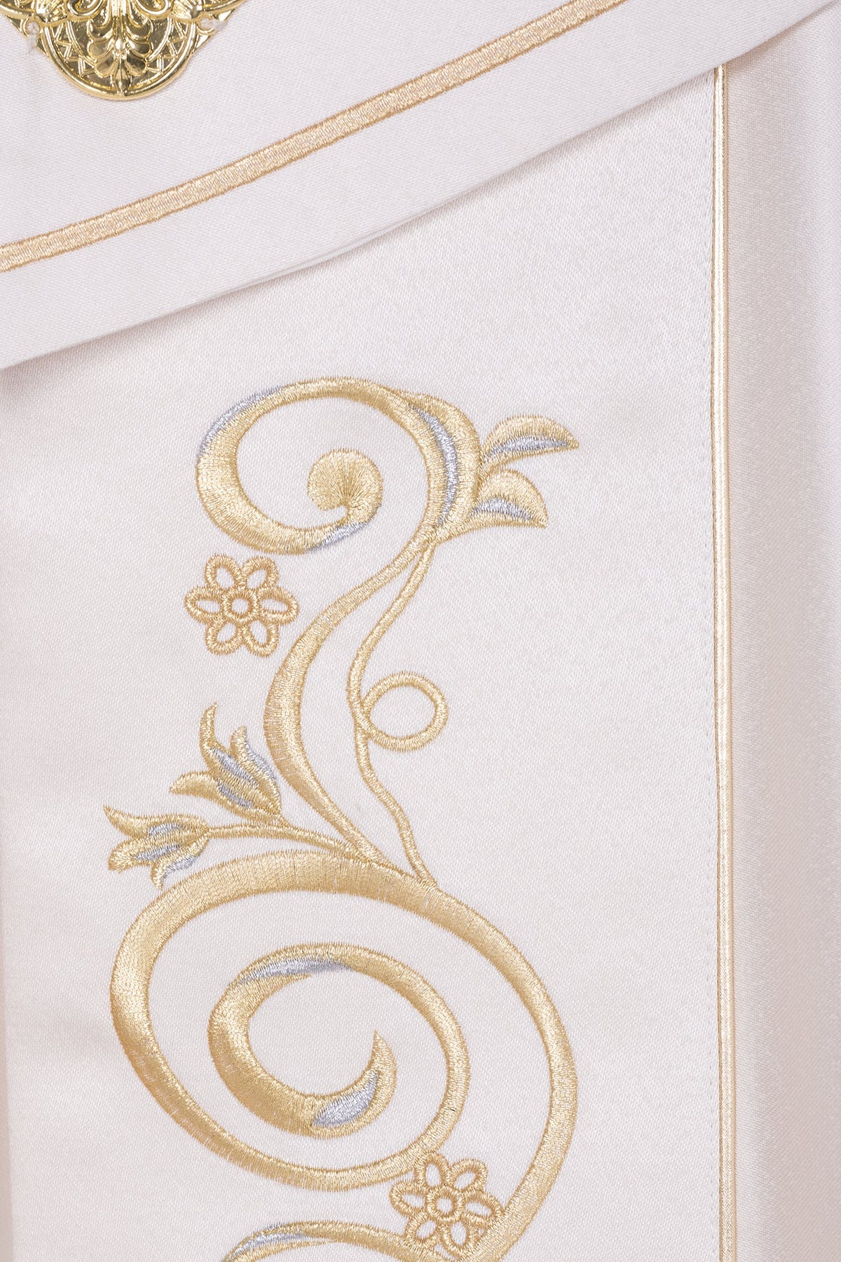 Close-up of ecru liturgical cope with gold and silver floral scroll embroidery
