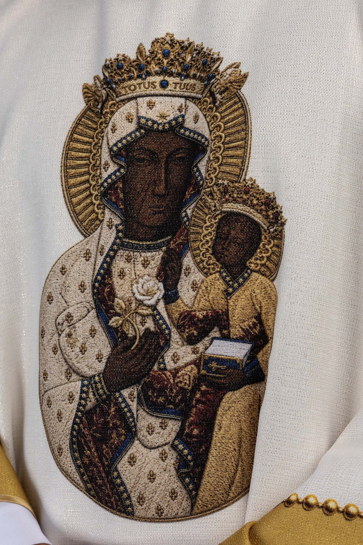 Close-up of the chasuble's Our Lady of Częstochowa image in blue, brown, white, and gold