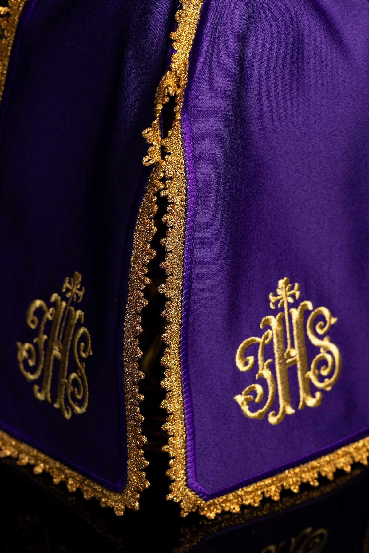 Detail view of the ciborium veil showing purple panels, gold trim and embroidered IHS motifs