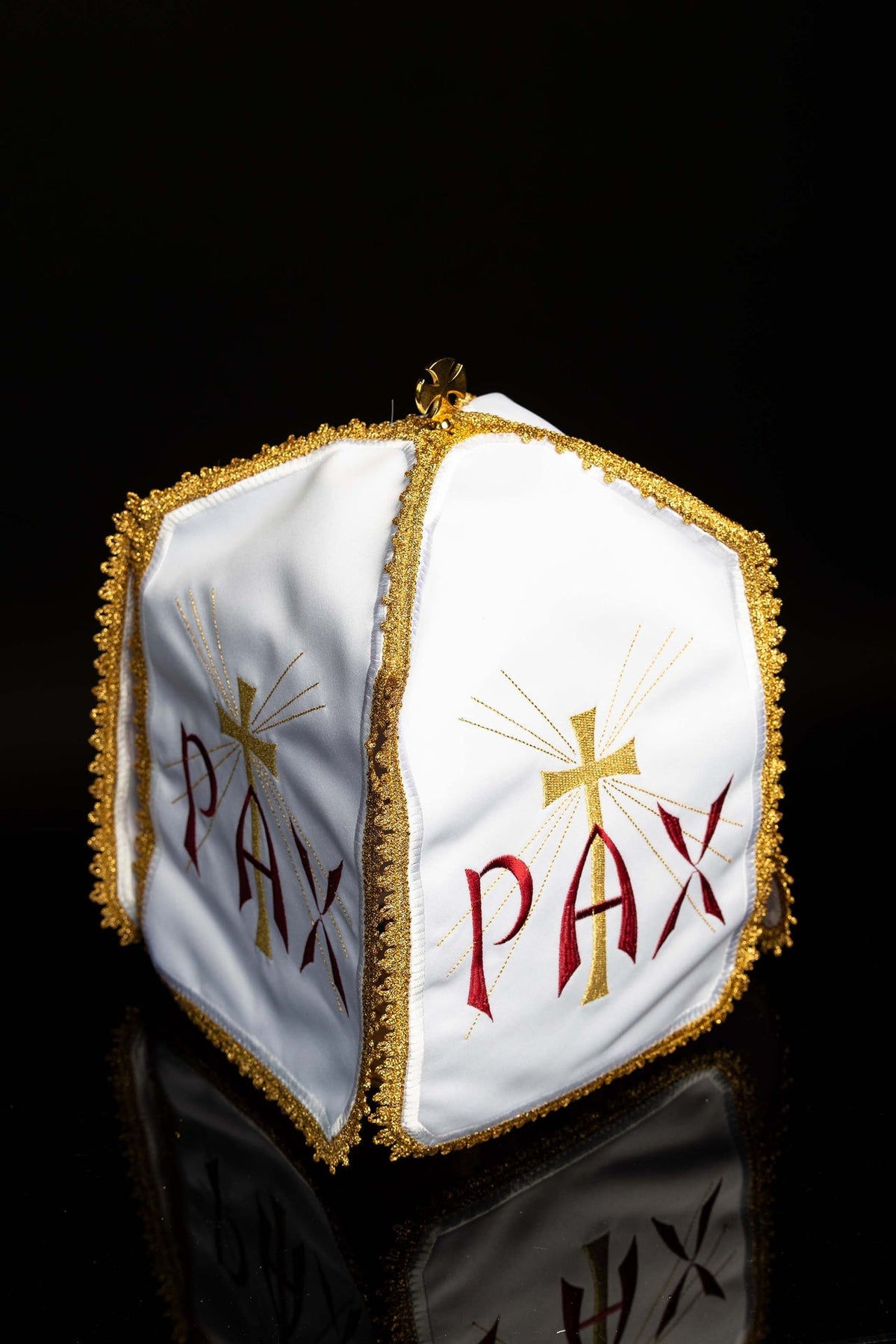 Three-quarter view of the ciborium veil showing matching embroidered panels and gold edging