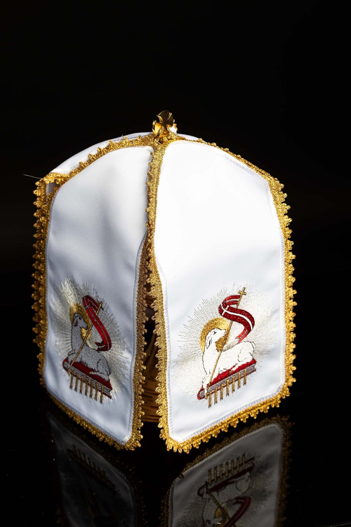 Three-quarter view of the ciborium veil showing matching Paschal Lamb panels and gold trim