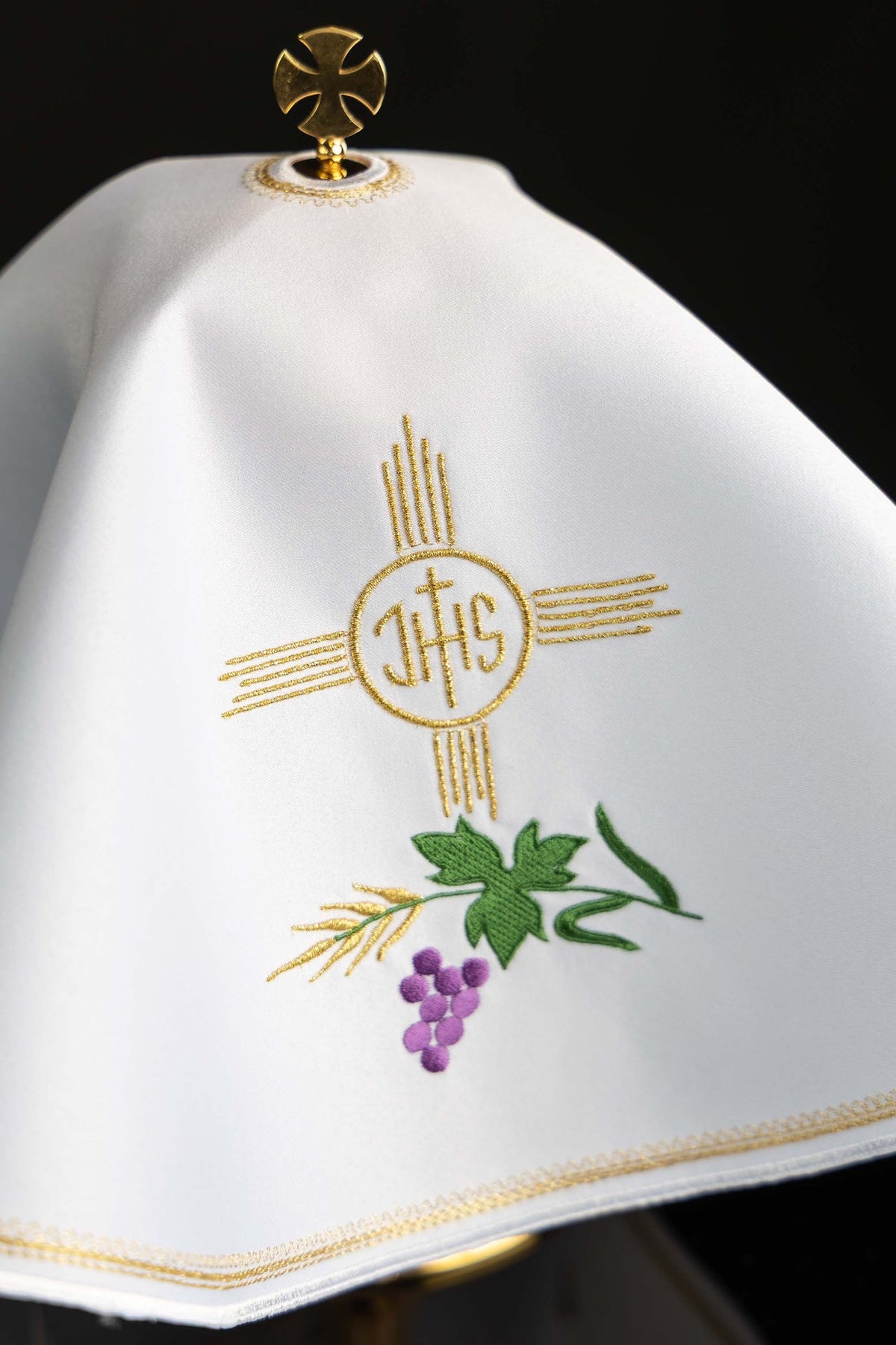 Close-up of the ciborium veil showing gold IHS, green leaves, wheat and purple grapes embroidery