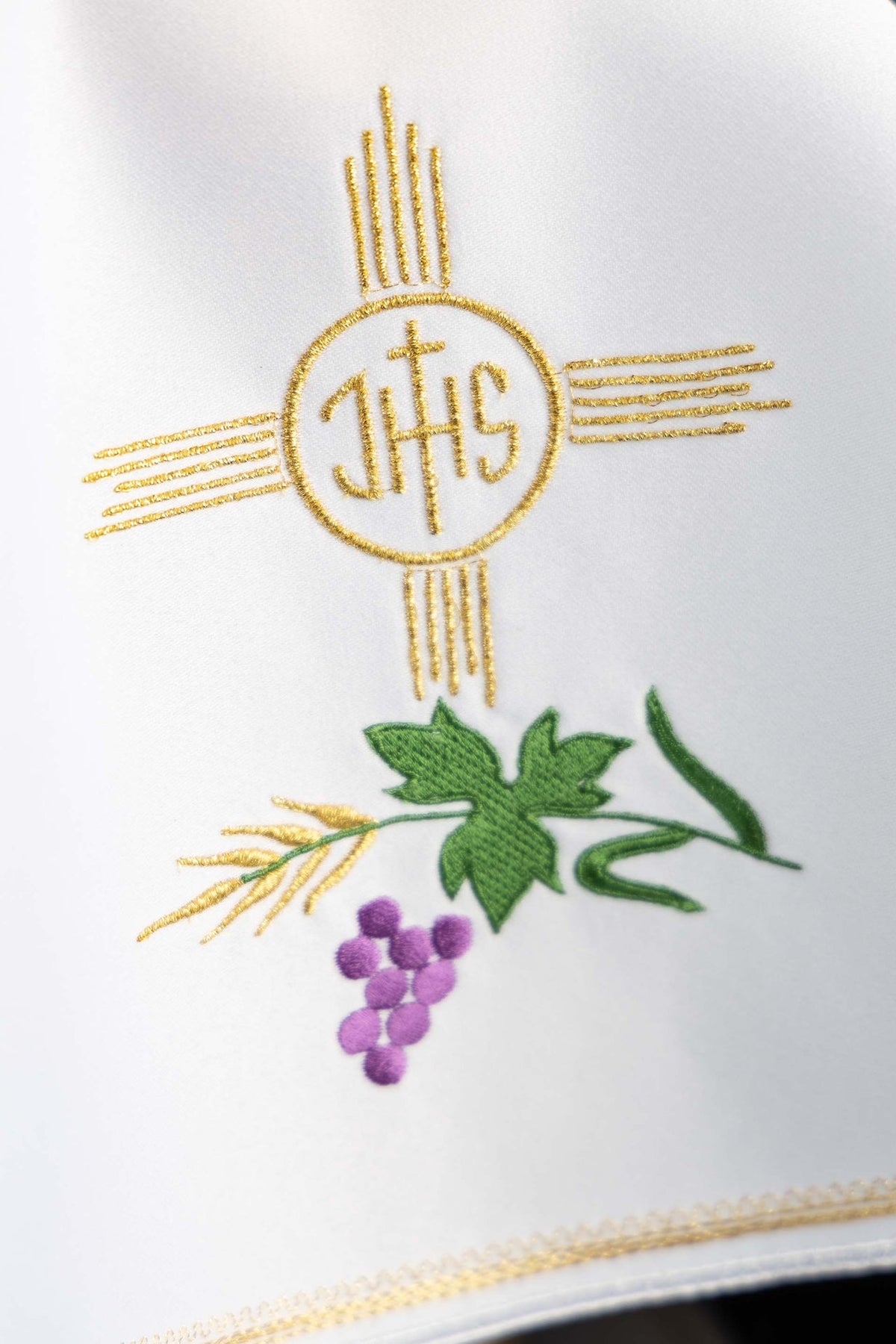 Close-up of the ciborium veil showing gold IHS and colorful Eucharistic embroidery