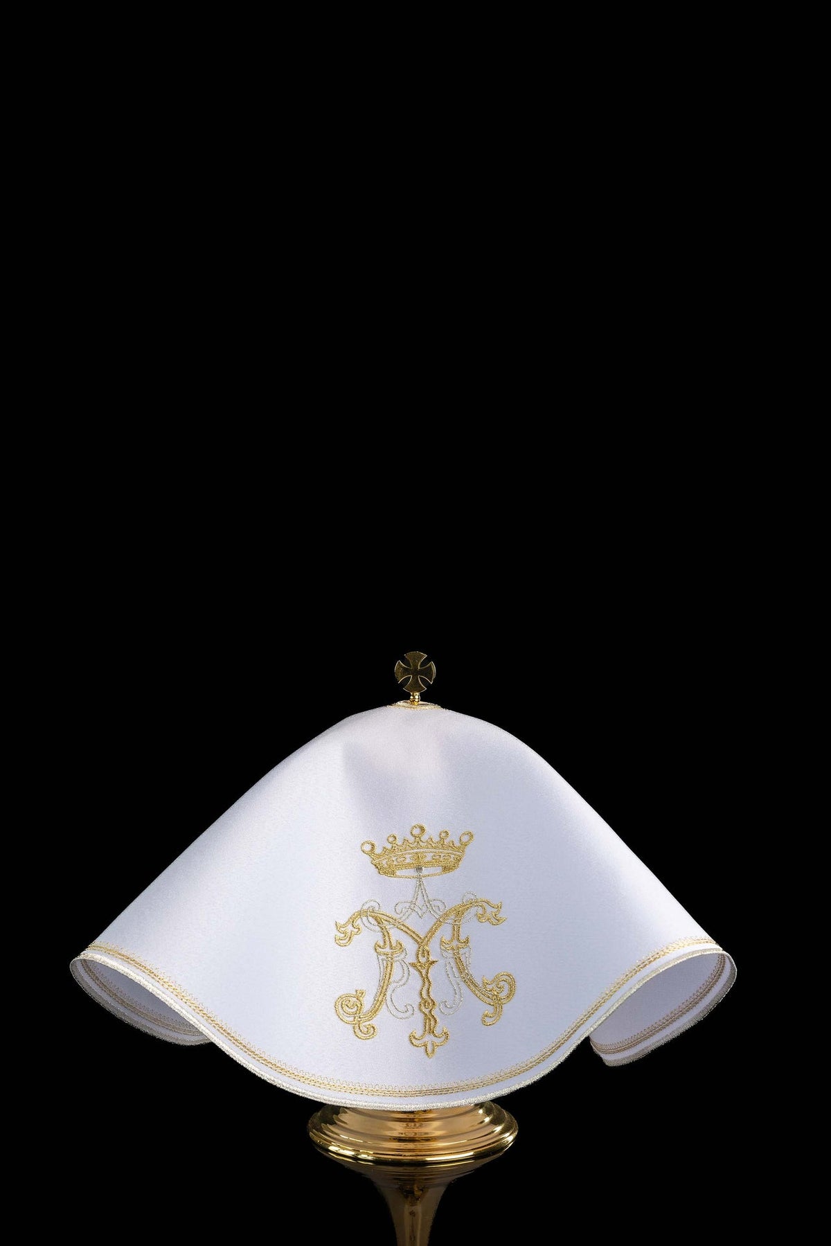 Front view of a white ciborium veil embroidered with gold Marian motif