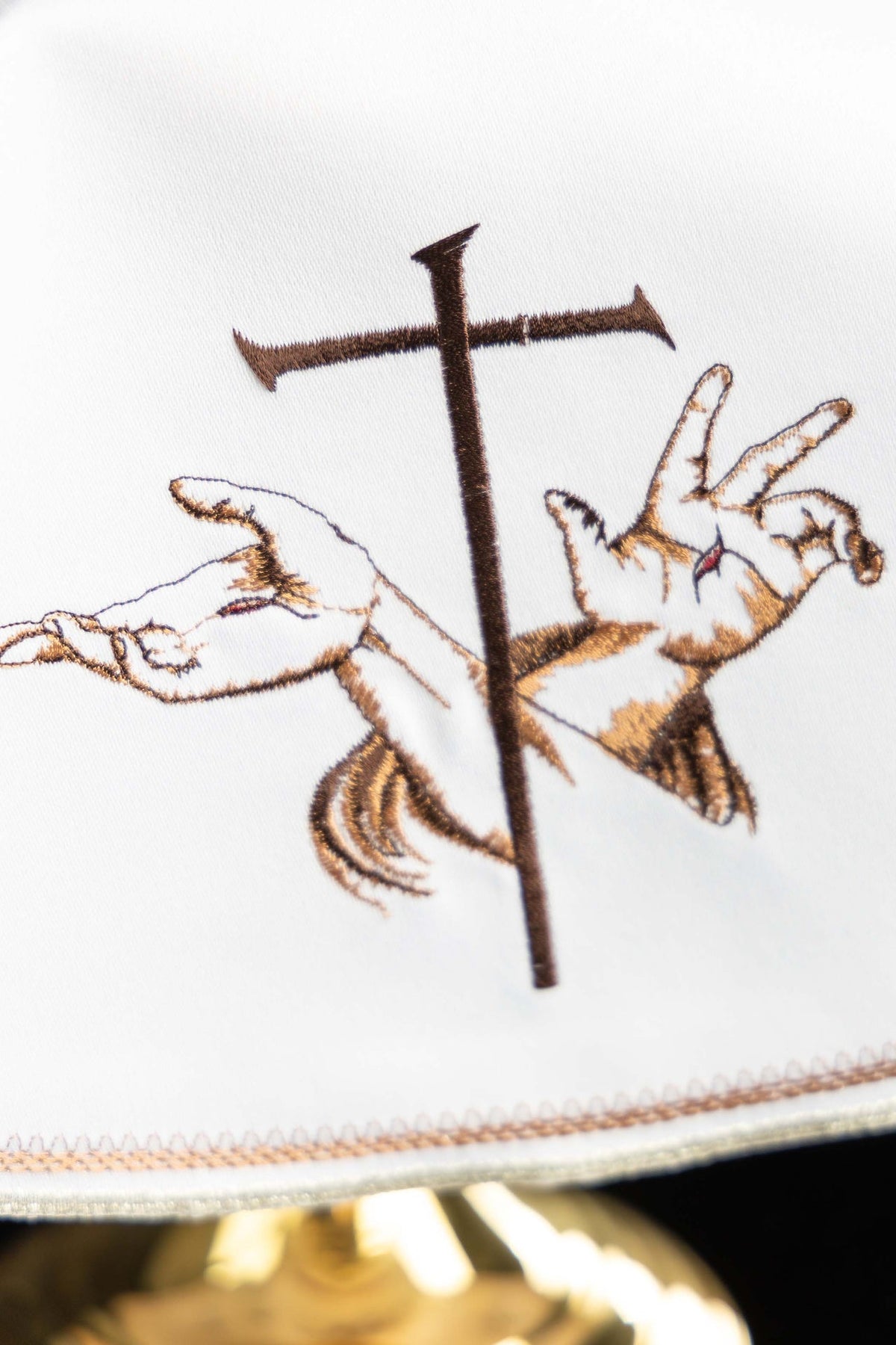 Close-up of ciborium veil embroidery showing crossed arms and a cross