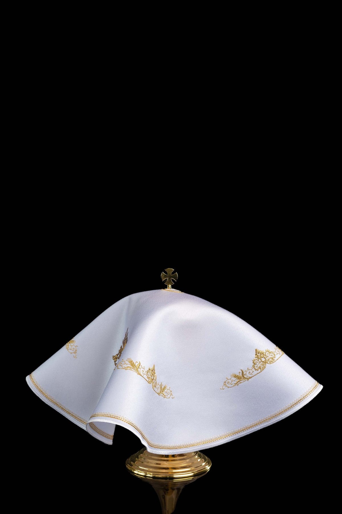 Side view of the white ciborium veil with gold floral embroidery