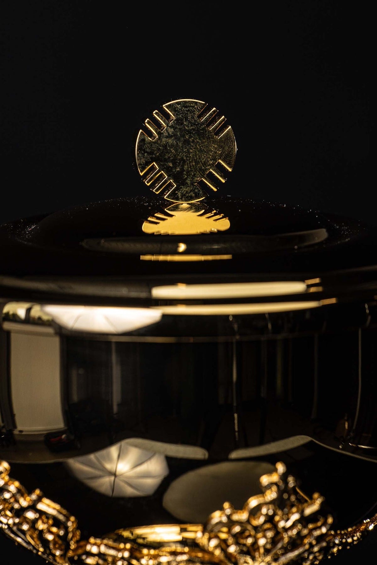 Top detail of gilded brass ciborium showing floral ornamentation and gold interior