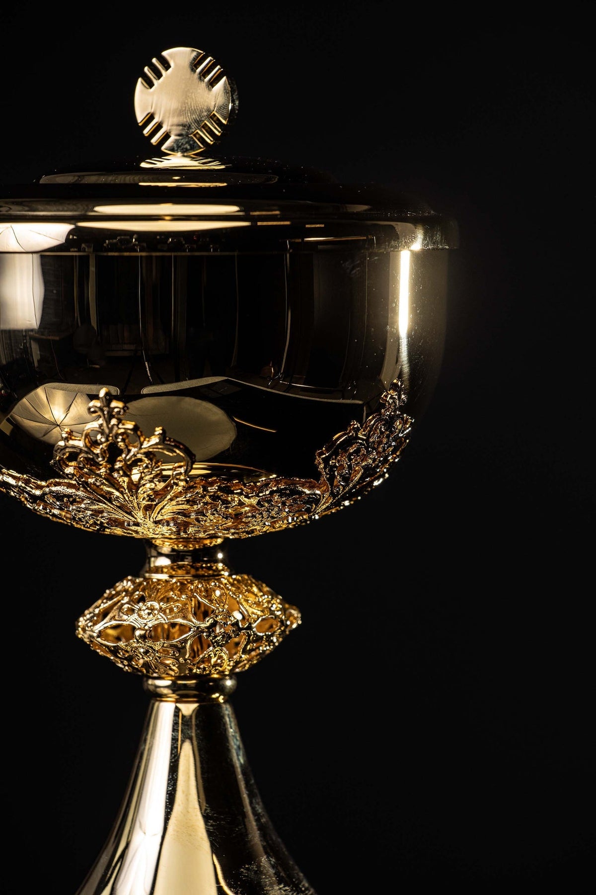 Side view of gilded brass ciborium showing the ornate bowl, stem and base