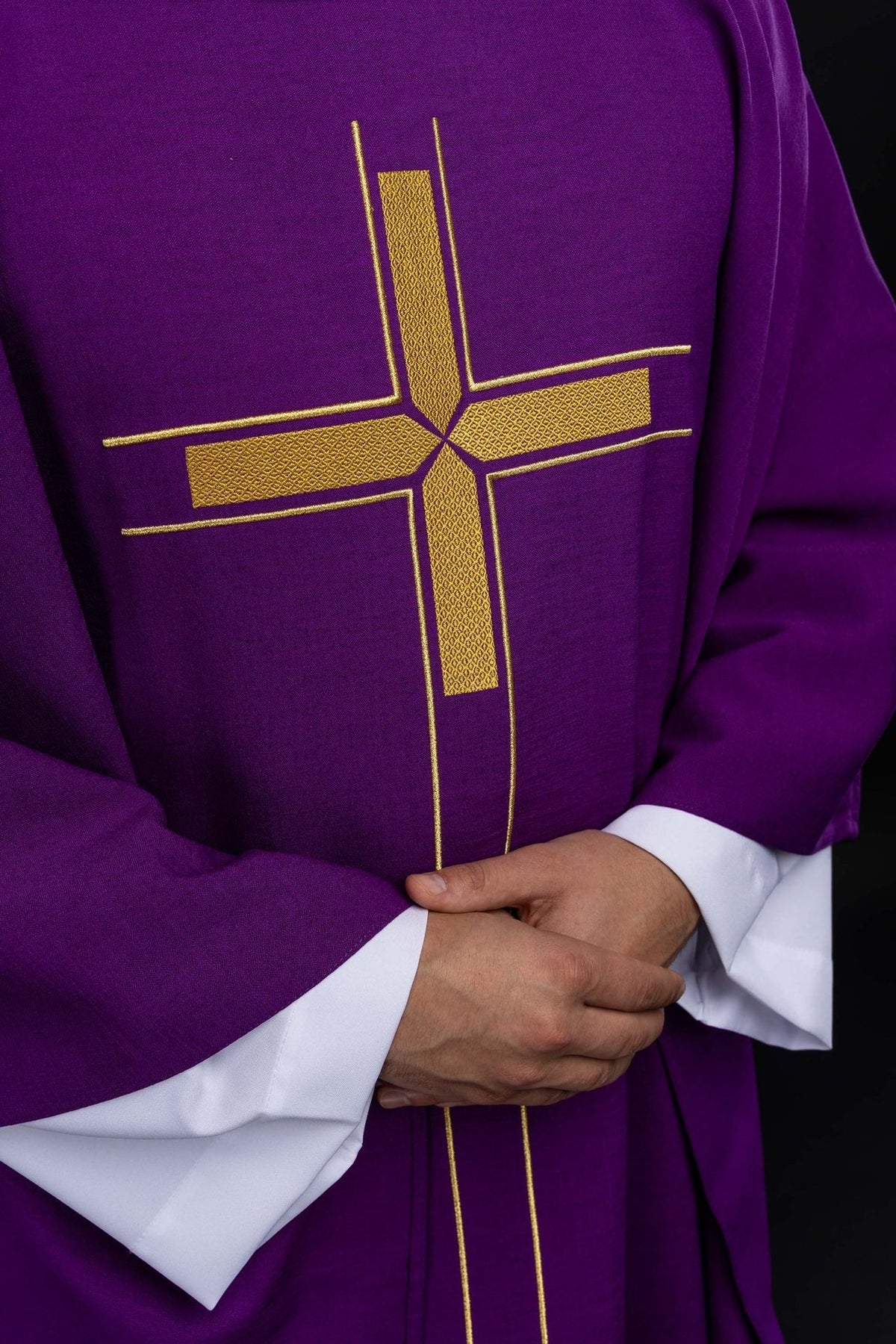 Close-up front view of the purple chasuble with embroidered gold cross