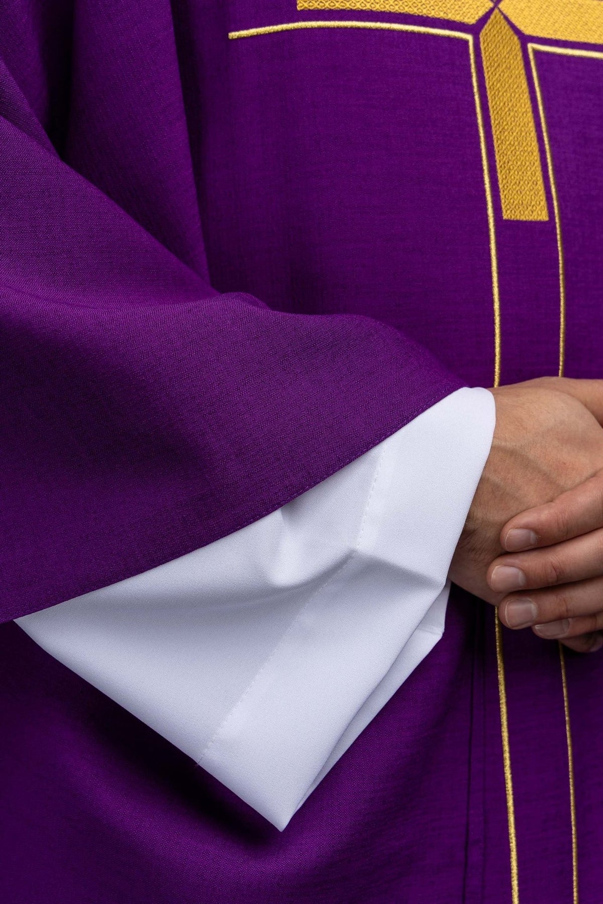 Close-up of the purple chasuble's stand-up collar and gold cross embroidery