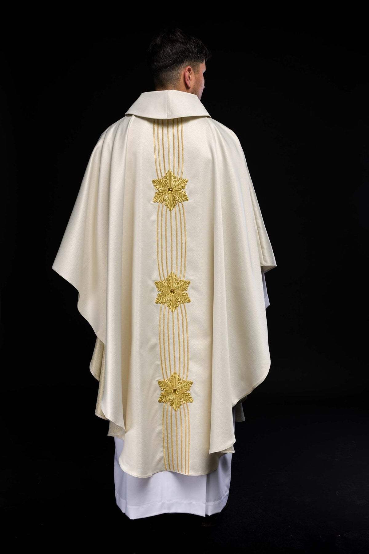 Close-up of the chasuble's gold floral embroidery with a central jewel