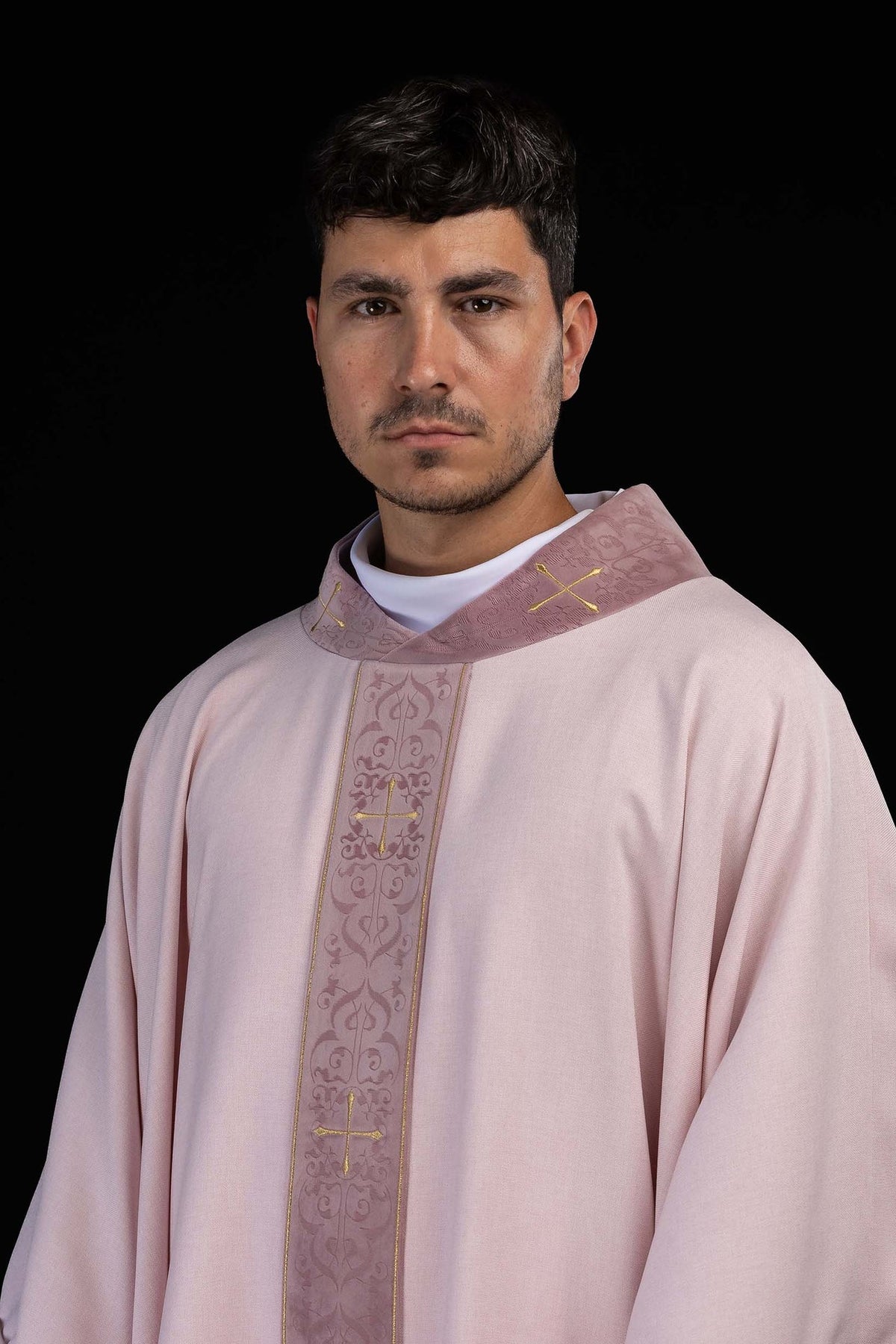 Close front view of the rose chasuble with gold crosses and embroidered orphrey